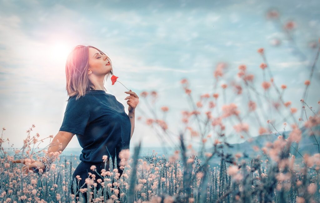 woman holding red flower